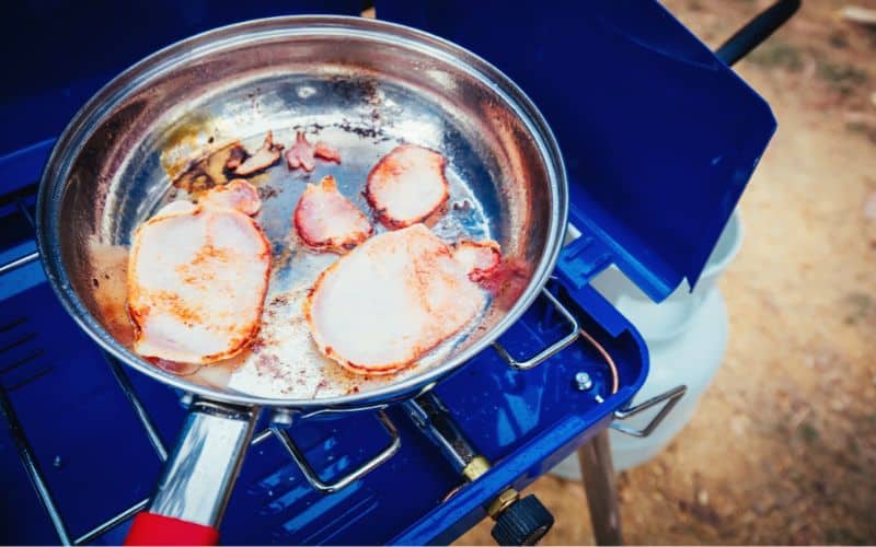 Frying off bacon on a propane stove 
