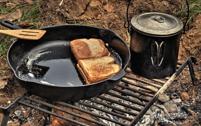 Grilled cheese sandwich made over a camping grate over fire