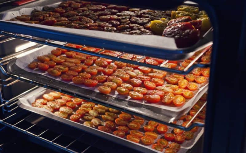 Trays of cherry tomatoes drying in the oven