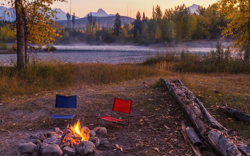 Camping chairs and campfire in Glacier National Park, Montana