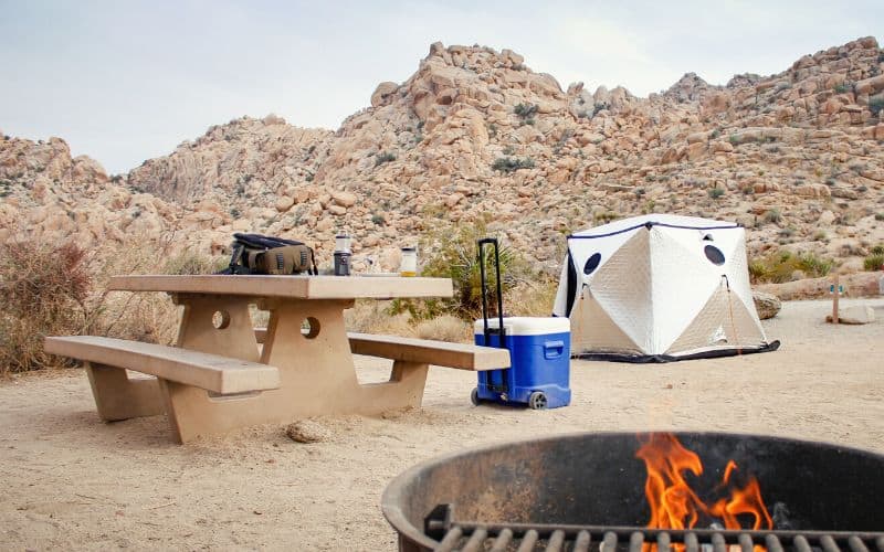 Desert campsite featuring hard sided cooler with wheels and long handle