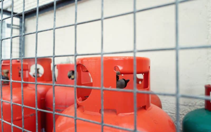 Gas cylinders stored behind a cage